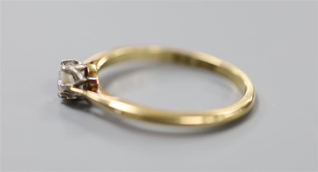 An 18ct and solitaire diamond ring, size Q, gross 2.5 grams, the stone weighing approximately 0.10ct.
